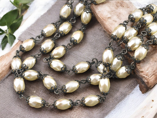 10x6mm Czech Glass Cream Twisted Oval Pearl Chain w/ Antique Bronze Caps -- Sold by the foot